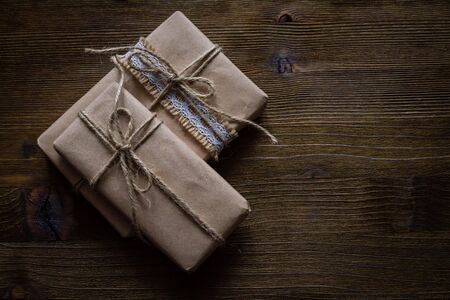 Presents in rustic wrap, wood background, copy space, top viewの写真素材