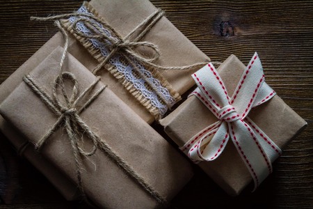 Presents in rustic wrap, wood background, copy space, top viewの写真素材