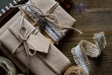 Presents in rustic wrap, wood background, copy space, top viewの写真素材