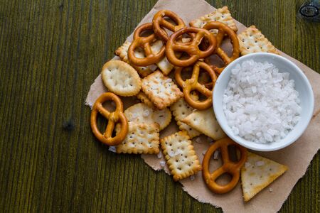 Selection of salty snacks, wood background, top viewの写真素材