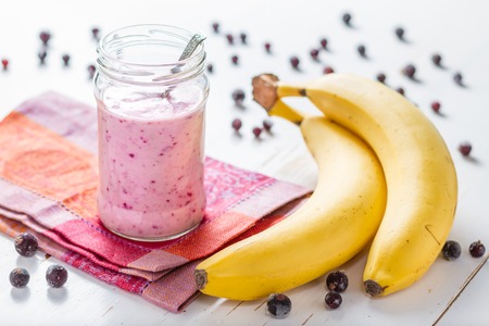strawberry and banana smoothie, glass jar, white wood backgroundの写真素材