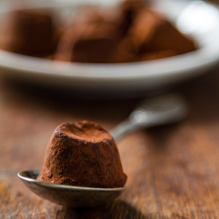 Truffles on white plate, rustic wood background, closeupの写真素材