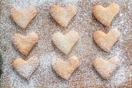 Heart shaped cookies on wood background, sugar powderの写真素材