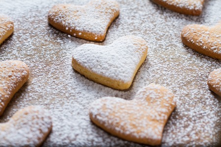 Heart shaped cookies on wood background, sugar powderの写真素材