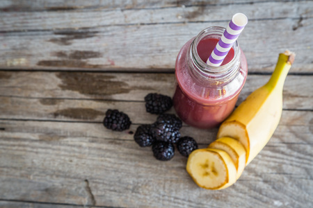 Purple smoothie on rustic wood background, copy spaceの写真素材