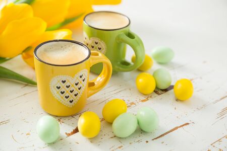 Coffe in green and yellow cups, tulips, copy spaceの写真素材
