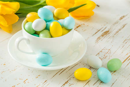 Colorful easter eggs in cup plate, copy spaceの写真素材