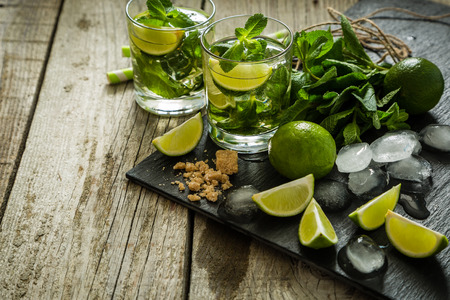 Mojito cocktail and ingredients, rustic wood background, copy spaceの写真素材