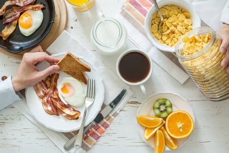 Family eating american breakfast wood table, , top view