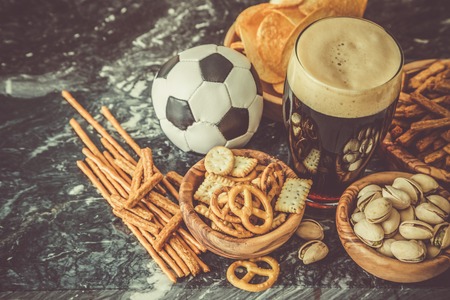 Selection of party food for watching football championship, copy space, tonedの写真素材