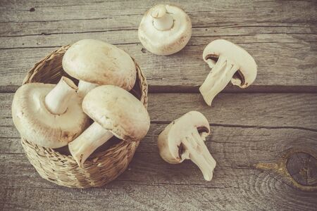 Raw mushrooms on rustic wood, copy space, tonedの写真素材