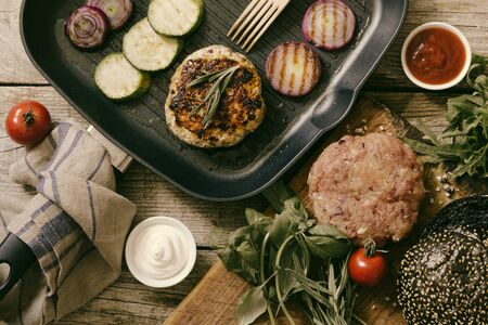 Preparing black burger and ingredients, top view, tonedの写真素材