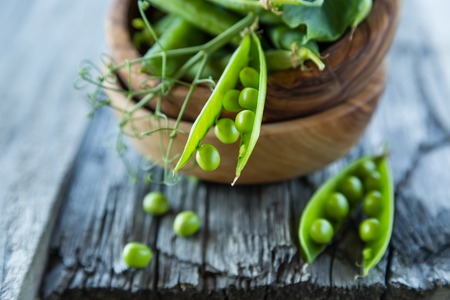 Green pias on rustic wood background, copy spaceの写真素材