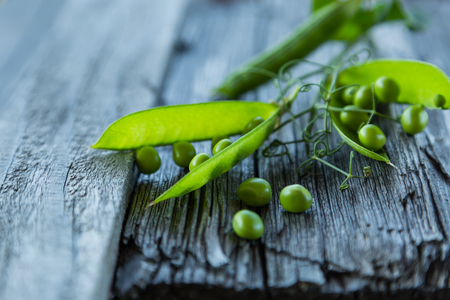 Green pias on rustic wood background, copy spaceの写真素材