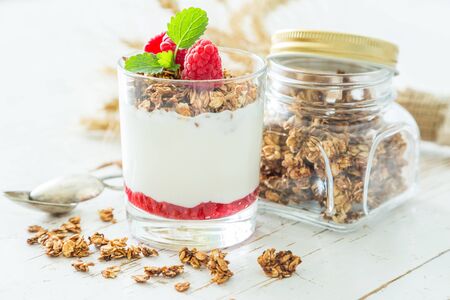 Granola with rasberry and yogurt in glass, copy spaceの写真素材