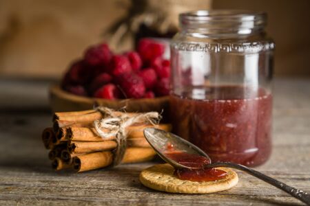 Rasberry jam with cinnamon on rustic background, copy spaceの写真素材
