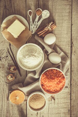 Ingredients for baking carrot cake, wood background tonedの写真素材