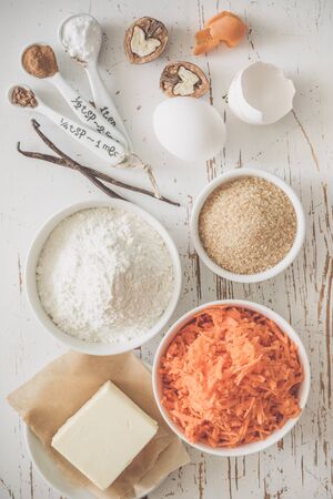 Ingredients for baking carrot cake, wood background tonedの写真素材