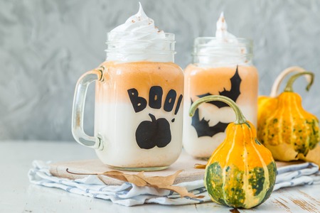 Halloween style pumpkin spice latte in glass jar, copy spaceの写真素材