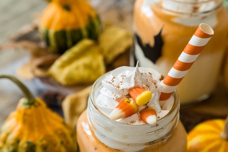 Halloween style pumpkin spice latte in glass jar, copy spaceの写真素材