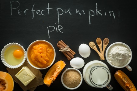 pumpkin pie ingredients in bowls on black backgroundの写真素材