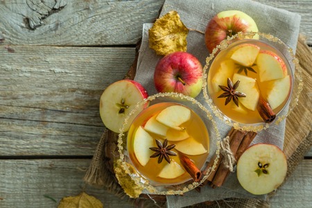 Apple cider with cinnamon and anise, wood background, copy spaceの写真素材