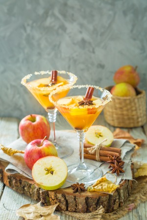 Apple cocktail with cinnamon and anise, wood background, copy spaceの写真素材