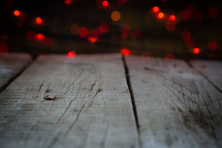 Rustic table with christmas lights blured in background, copy spaceの写真素材