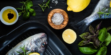 Raw fish with herbs and spices, top viewの写真素材
