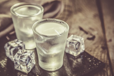 Vodka in shot glasses on rustic wood backgroundcopy spaceの写真素材