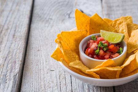 Nachos and salsa sauce ingredients on wood background, copy spaceの写真素材