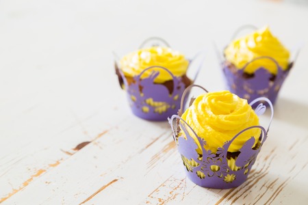 Easter cupcakes with eggs and flaffy willow, wood backgroundの写真素材
