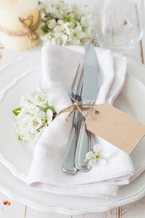 Spring table setting with white flowers, copy spaceの写真素材