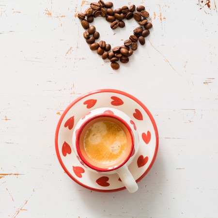 Love and coffee concept - heart shape with beansの写真素材