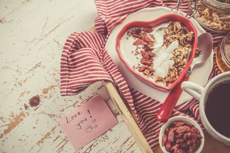Valentines day breakfast - granola with yogurt, goji berries and coconutの写真素材