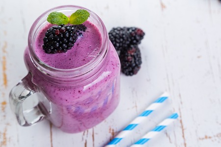 Blackberry jogurt smoothie in glass jarの写真素材