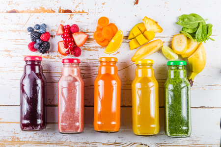 Selection of colourful smoothies on rustic wood backgroundの写真素材