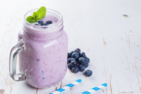 Blueberry jogurt smoothie in glass jarの写真素材