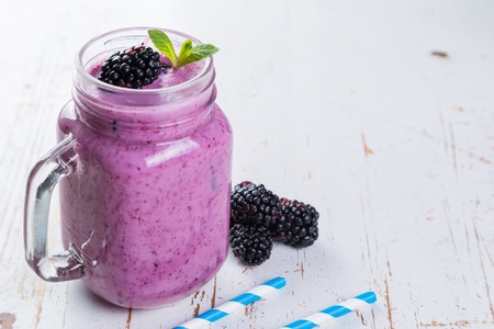 Blackberry jogurt smoothie in glass jarの写真素材