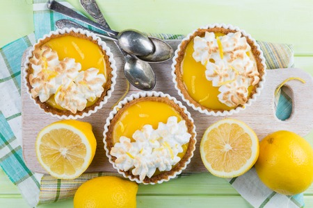 Lemon meringue mini pies on rustic backgroundの写真素材