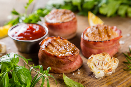 Roasted filet mignon with herbs and spices, rustic wood backgroundの写真素材