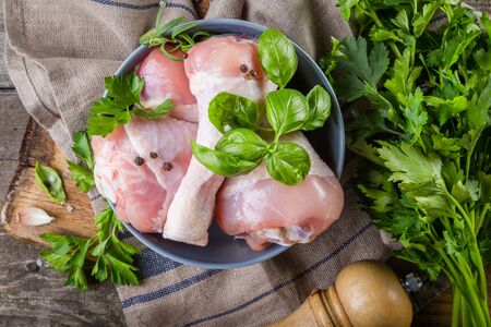 Raw chicken legs for bbc with herbs and spicesの写真素材