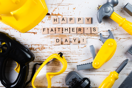 Father's day concept - child tools on wood background, top viewの写真素材