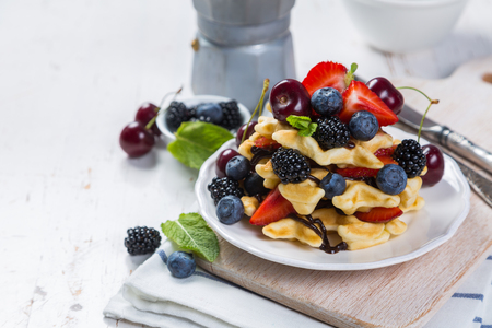 Breakfast - waffles with berries on white plate, copy spaceの写真素材