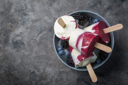 Berry popsicles on rustic background, copy spaceの写真素材