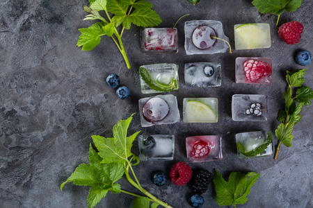 Frozen berries in ice cubes, copy spaceの写真素材