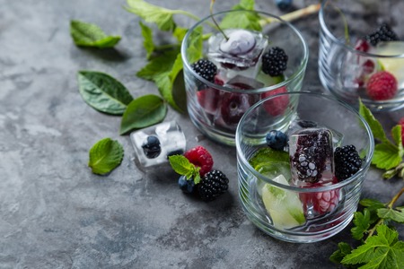 Frozen berries in ice cubes, copy spaceの写真素材