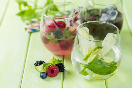 Selection of colorful infused waters in glasses, rustic backgroundの写真素材