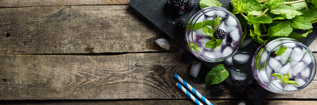 Blackberry mojito and ingredients on rustic backgroundの写真素材