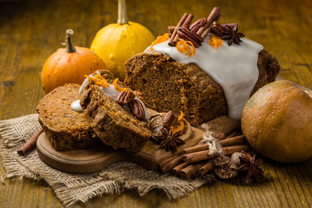 Carrot cake with autumn decorations, rustic wood backgroundの写真素材